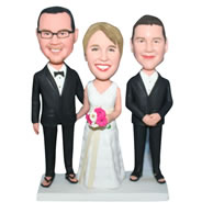 Groom in black suit and bride in white wedding dress with their groomsman bobblehead