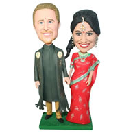 Groom in dark green long gown and bride in red dress bobblehead