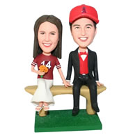 Boyfriend in black suit and girlfriend in red shirt handing with a bunch of flowers bobblehead