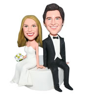Groom in black suit and bride in white wedding dress handing a bunch of flowers bobblehead