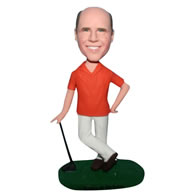 Man in orange shirt playing golf bobblehead