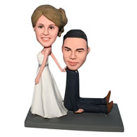 Funny groom in black suit and bride in white wedding dress bobblehead