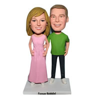 Husband in green shirt and wife in pink dress custom bobblehead