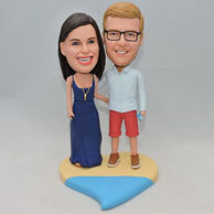 Sweet couple bobblehead standing on a colorful heart base