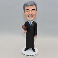 Personalized judge bobblehead with black outfit and a brown hammer