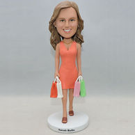 Beautiful lady bobblehead with several colorful shopping bag