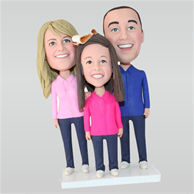 Father in blue shirt and mom in pink shirt with their lovely daughter in rose shirt custom bobbleheads