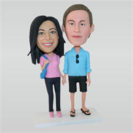 Husband in blue shirt and wife in pink shirt custom bobbleheads