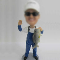 Man with fish bobble head doll