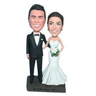 Groom in black suit and bride in white wedding dress handing a bunch of flowers bobblehead