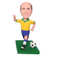 Man in yellow shirt playing soccer ball bobblehead