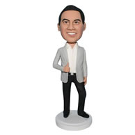 Handsome man in beige suit coat matching with black pants bobblehead