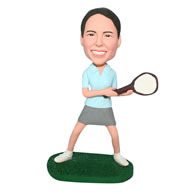 Woman in light green shirt hangding with tennis racket bobblehead