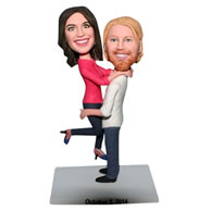 Husband in white T-shirt carrying his wife in rose T-shirt bobblehead
