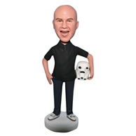 Man in black shirt handing with a white cap bobblehead