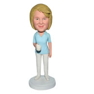 Woman in blue shirt handing a cup bobblehead