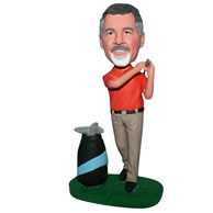 Man in orange shirt playing golf bobblehead