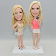 Two girls bobbleheads wear beautiful clothes