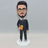 Personalized bobbleheads in black outfits with a book in his hand