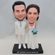 Custom Wedding Bobbleheads in white clothes holding blue flower