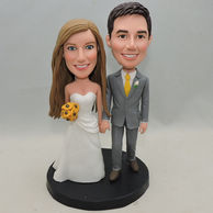 Creative wedding bobbleheads with white wedding gowns and flowersin hand
