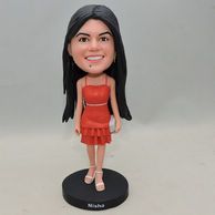 Pretty lady bobblehead with trapeze dress and high-heeled shoes