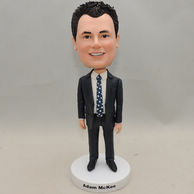 Custom-built smiling businessman bobbleheads with black suit