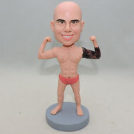 Strong man bobblehead with tattoo on left hand