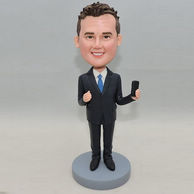 Confident businessman bobblehead with phone