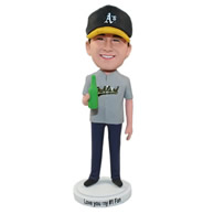 Man holding a bottle of beer in A's hat bobble heads