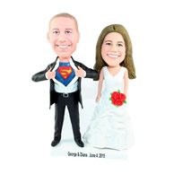 Custom special wedding cake topper of bride holding suppermen logo out bobble heads