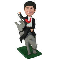 The man is sitting on a fake rhinos back custom bobbleheads