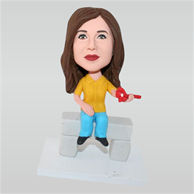 Woman in yellow T-shirt holding a flower custom bobbleheads