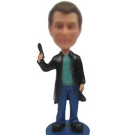 Man with gun bobble head doll